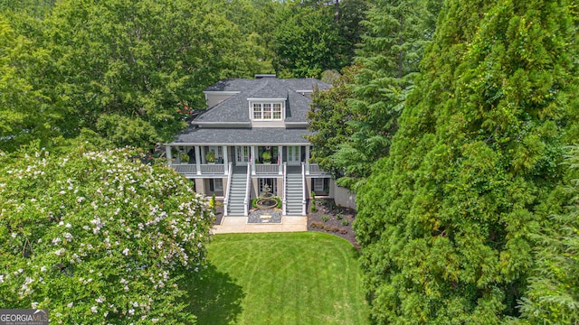 back of house with a lawn