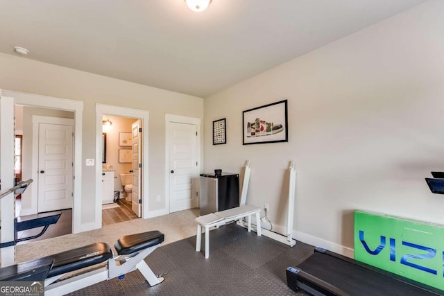 exercise room featuring light carpet