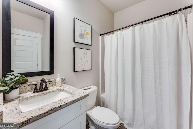 bathroom with vanity, curtained shower, and toilet