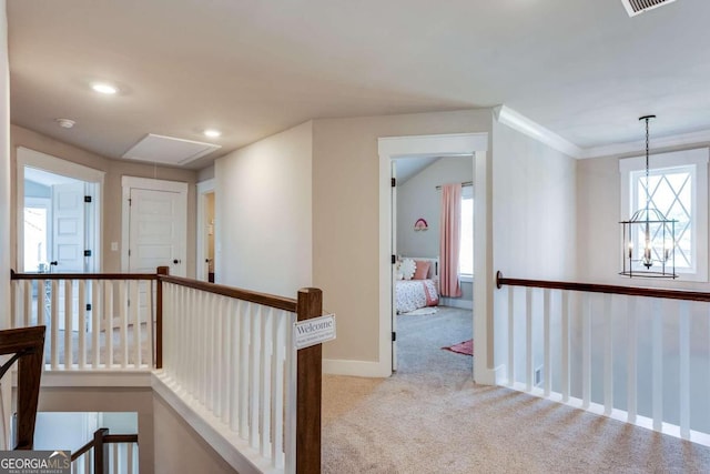 corridor featuring crown molding and light carpet