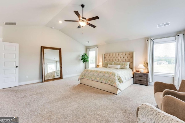 bedroom with ceiling fan, light carpet, and vaulted ceiling