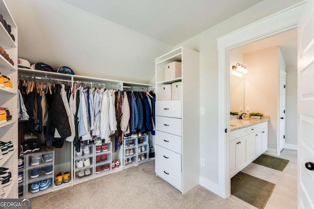 spacious closet featuring light carpet and sink