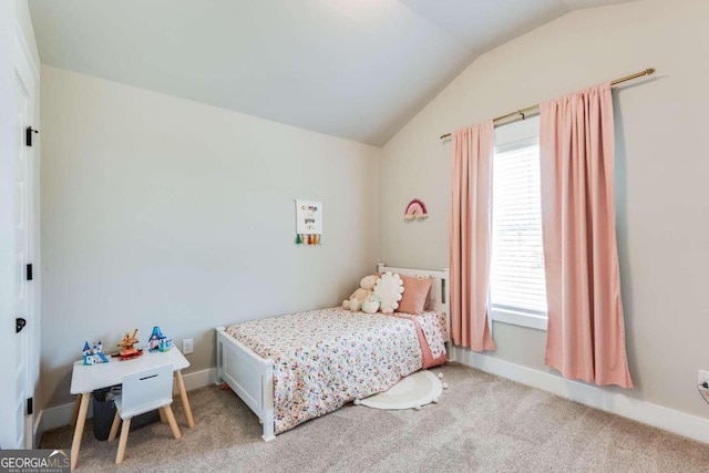 bedroom featuring light colored carpet and lofted ceiling