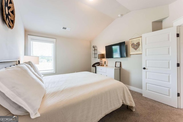 carpeted bedroom with vaulted ceiling