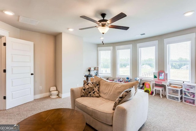 living room featuring carpet flooring and ceiling fan