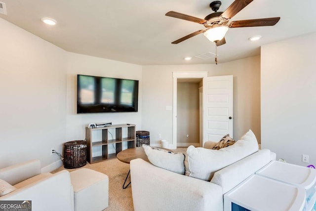 carpeted living room featuring ceiling fan