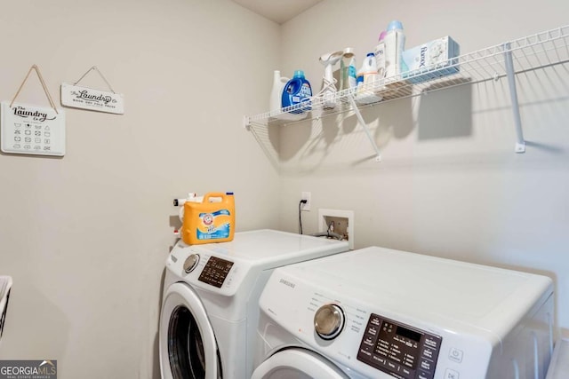 clothes washing area with separate washer and dryer