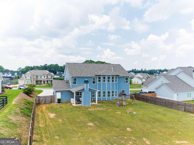 rear view of property featuring a yard