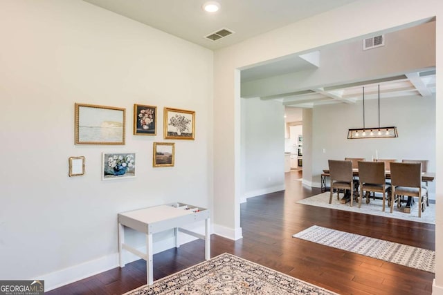 interior space with beamed ceiling, dark wood-type flooring, and coffered ceiling