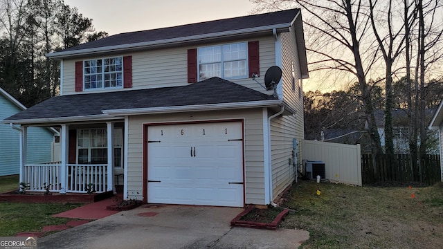 traditional-style home with driveway, roof with shingles, fence, cooling unit, and a porch