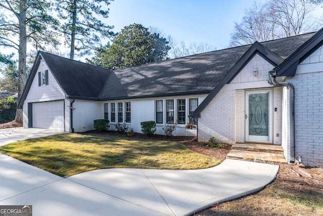 view of front of home with a front yard and a garage