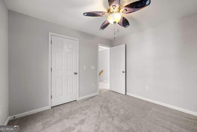 unfurnished bedroom featuring ceiling fan and light carpet