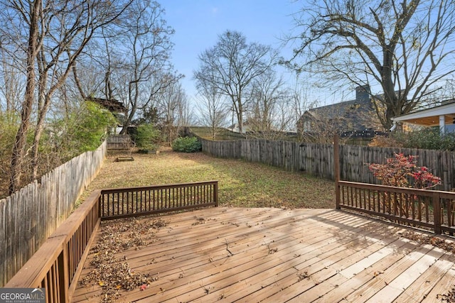 wooden deck featuring a lawn