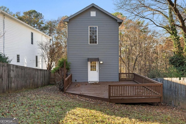 back of house with a wooden deck