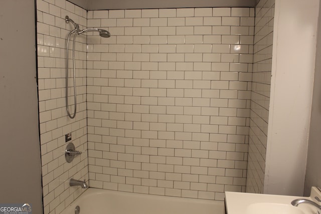 bathroom with sink and tiled shower / bath