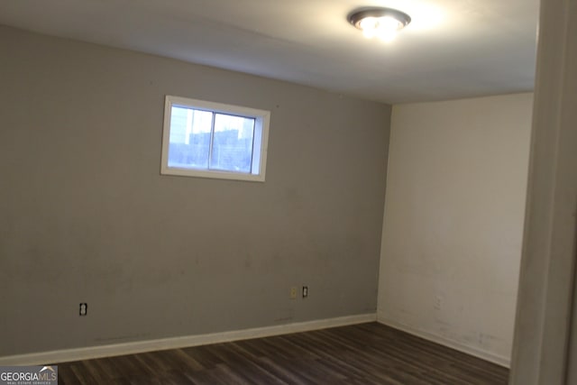 empty room with dark wood-type flooring