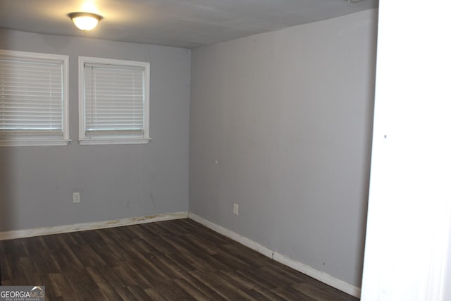 empty room with dark hardwood / wood-style floors