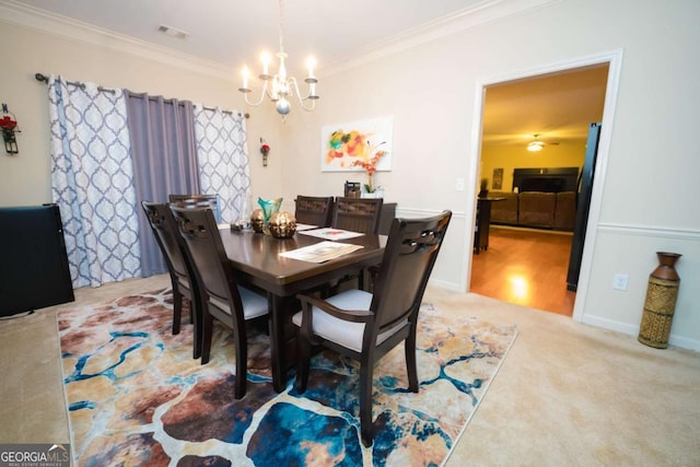 dining space with carpet, an inviting chandelier, and ornamental molding