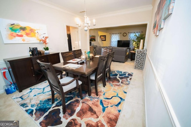 carpeted dining area featuring a chandelier and ornamental molding