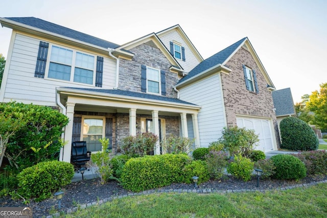 view of front of home with a porch and a garage