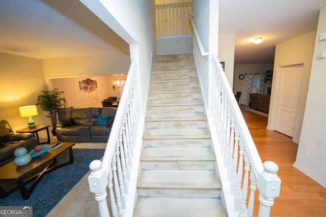 staircase with hardwood / wood-style floors