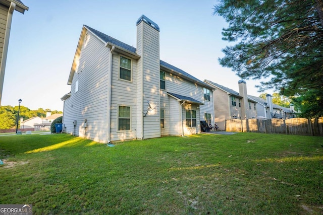 back of house with a lawn