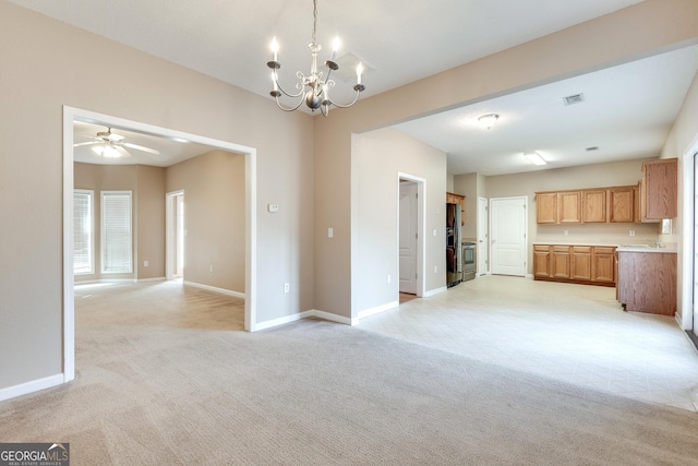 interior space featuring ceiling fan with notable chandelier, light colored carpet, stainless steel refrigerator with ice dispenser, and hanging light fixtures