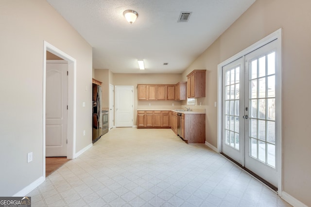 kitchen with french doors, stainless steel appliances, and sink