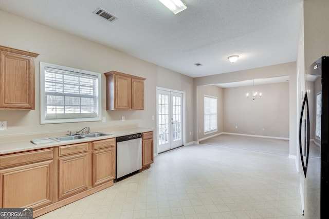 kitchen with sink, french doors, stainless steel appliances, an inviting chandelier, and a textured ceiling