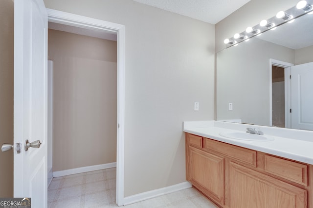 bathroom featuring a textured ceiling and vanity