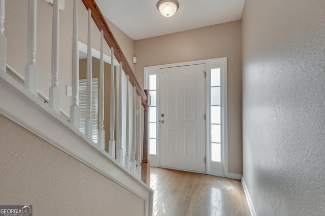 entrance foyer with light hardwood / wood-style floors and a wealth of natural light