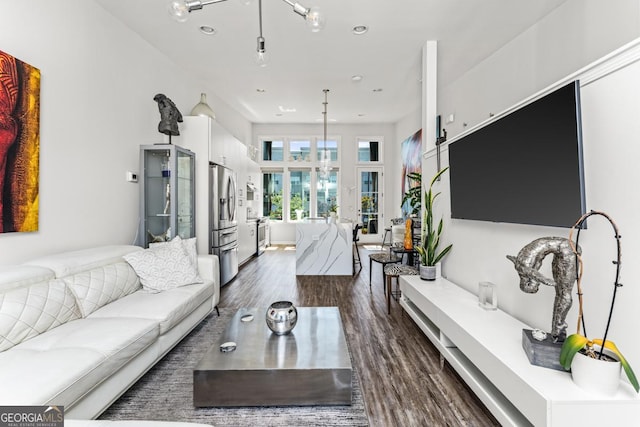 living area with dark wood-style floors and recessed lighting