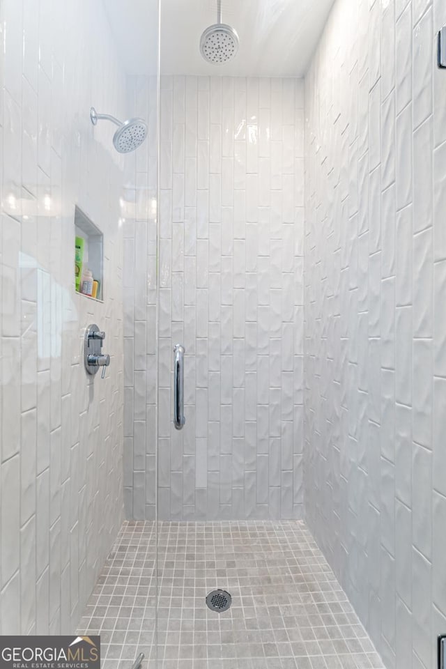 bathroom with a tile shower