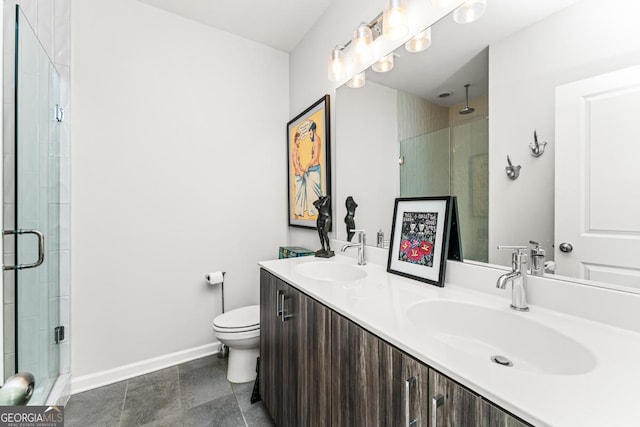 bathroom featuring toilet, a shower stall, baseboards, and a sink