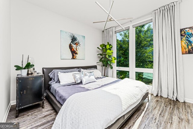 bedroom with a chandelier and hardwood / wood-style flooring