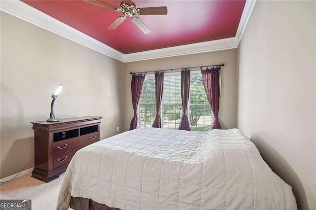 carpeted bedroom featuring ceiling fan and crown molding