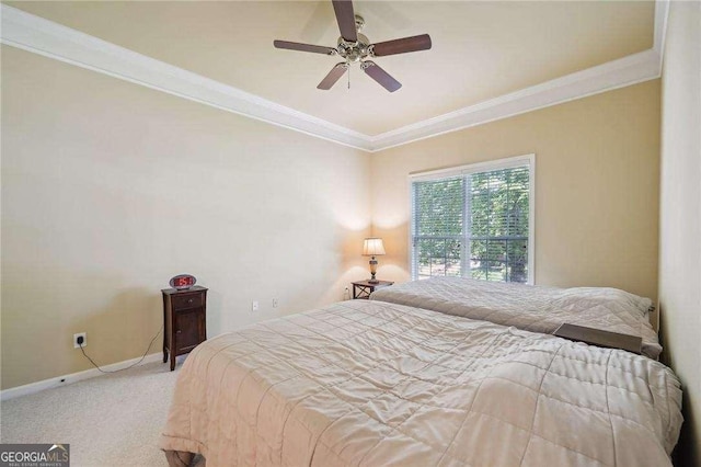 carpeted bedroom featuring ceiling fan and crown molding