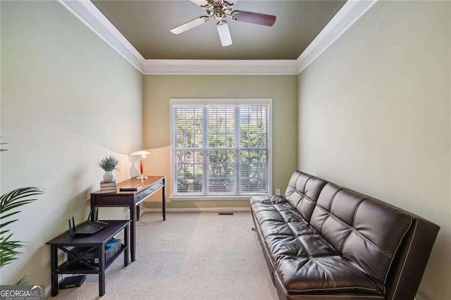 sitting room featuring ceiling fan, light colored carpet, and ornamental molding