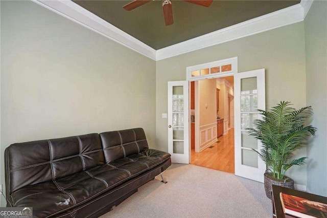 living room with carpet flooring, ceiling fan, ornamental molding, and french doors