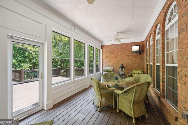 sunroom / solarium featuring a wealth of natural light and ceiling fan