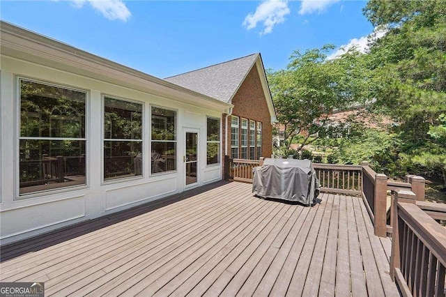 wooden deck featuring a grill