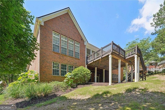 rear view of house featuring a wooden deck