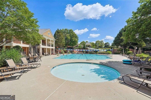 view of swimming pool with a patio