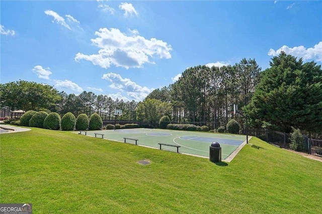 view of sport court with a lawn