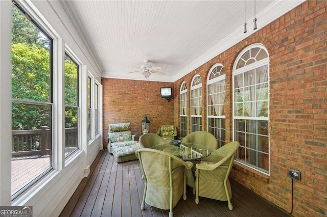 sunroom with ceiling fan and a healthy amount of sunlight