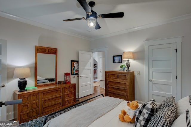 bedroom with ceiling fan and crown molding