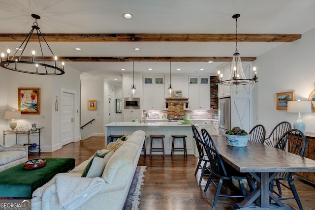 dining room featuring beam ceiling, dark hardwood / wood-style flooring, and an inviting chandelier