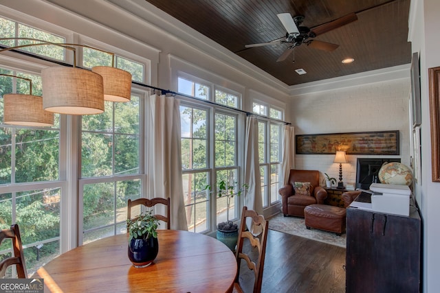 sunroom featuring ceiling fan and wooden ceiling