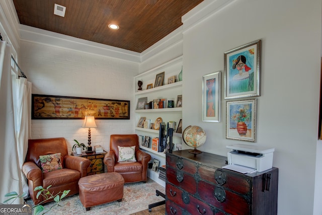 sitting room featuring built in features, wooden ceiling, and brick wall