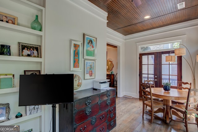 dining room with built in shelves, french doors, wooden ceiling, light hardwood / wood-style flooring, and plenty of natural light